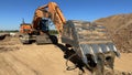 Huge excavator shovel in the foreground on a sunny day