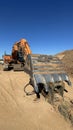 Huge excavator shovel in the foreground on a sunny day. Vertical