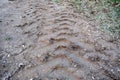 Huge excavator tyre traces on the soil and mud