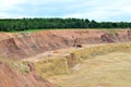 Huge excavators with electric shovel working in the quarry. Big dump trucks transport of minerals in the limestone open-pit mining Royalty Free Stock Photo