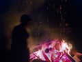 Huge fire at night and young people around. Royalty Free Stock Photo