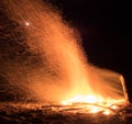 Hikers crowd around a beach bonfire at the end of the heaphy trail on New Zealands West Coast.