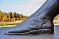 Huge foot, trees and blue sky background