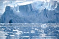 Disruptling glacier wall in Antarctica, majestic blue and white ice wall with gate in front.