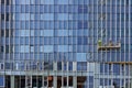 The huge glass walls of the modern office building repaired and Royalty Free Stock Photo