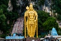 Huge gold statue of hindu god hanuman at entrance of batu caves during cloudy day in kuala lumpur malaysiahuge blue statue of hind Royalty Free Stock Photo