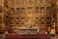 Huge golden altar decorated with statues and ornaments in Seville cathedral, Spain