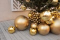 Huge golden balls of different sizes under the Christmas tree in the street square. Outdoor holiday decoration . selective focus Royalty Free Stock Photo