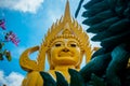 A huge golden Buddha statue on the territory of the temple in Phatthalung in Thailand