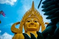 A huge golden Buddha statue on the territory of the temple in Phatthalung in Thailand
