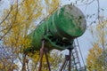 Huge green aluminium barrel on rusty metal support used as water tower. Royalty Free Stock Photo