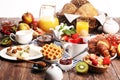 Huge healthy breakfast on table with coffee, orange juice, fruits, waffles and croissants. Good morning concept Royalty Free Stock Photo