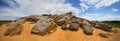 Huge heap of stones among a sandy desert at the hot summer day Royalty Free Stock Photo
