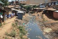 Huge heaps of garbage and a dirty river in the slums of Nairobi - one of the poorest places in Africa