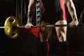 Huge heavily athlete approaches the bar in order to perform an e Royalty Free Stock Photo