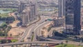 Huge highway crossroad junction between JLT district and Dubai Marina intersected by Sheikh Zayed Road aerial all day.