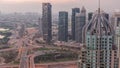 Huge highway crossroad junction between JLT district and Dubai Marina night to day timelapse.