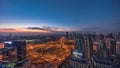 Huge highway crossroad junction between JLT district and Dubai Marina night to day .