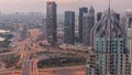 Huge highway crossroad junction between JLT district and Dubai Marina night to day timelapse.