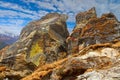 Big Himalayan rocks with blue sky and clouds in background