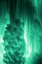 Huge ice icicles. Large blocks of ice frozen waterfall or water. Light green ice background. Frozen stream waterfal