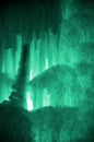 Huge ice icicles. Large blocks of ice frozen waterfall or water. Light green ice background. Frozen stream waterfal