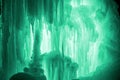 Huge ice icicles. Large blocks of ice frozen waterfall or water. Light green ice background. Frozen stream waterfal
