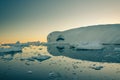 Huge iceberg with cave inside reflects in the sea, Ilulissat Icefjord, Greenland