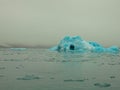 Iceberg drifting in the polar ocean in the arctic. Cloudy Day. Tourism and vacations concept.