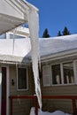 Dangerously huge icicle hanging from an eavestrough Royalty Free Stock Photo