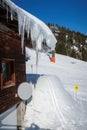 huge icicles hang from a roof in the mountains