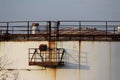 Huge industrial storage tank with stairs. old rusty tank. Royalty Free Stock Photo