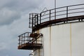 huge industrial tank with a metal ladder against the blue sky Royalty Free Stock Photo