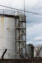 huge industrial tank with a metal ladder against the blue sky Royalty Free Stock Photo