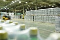 huge industrial warehouse with plastic food wrap wrapped plastic bottles with carbonated drinks, water or beer.