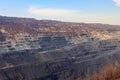 Huge iron ore quarry with working dump trucks and excavators Royalty Free Stock Photo