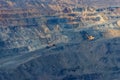 Huge iron ore quarry with working dump trucks and excavators Royalty Free Stock Photo