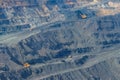 Huge iron ore quarry with working dump trucks and excavators Royalty Free Stock Photo