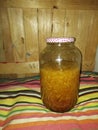 huge jar with honey liquid and ginger