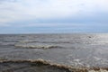 Huge lake with waves and sky with clouds