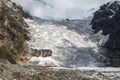 Huge Lardaad glacier icefall with small waterfall view from bottom in mountains of Svaneti Georgia on a sunny day