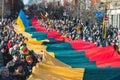Huge Lithuanian flag along Gedimino avenue in Vilnius, carried by people with Lithuanian and Ukrainian flags