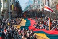 Huge Lithuanian flag along Gedimino avenue in Vilnius, carried by people with Lithuanian and Ukrainian flags