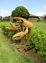 Huge lobster stand holding glass lantern by its mouth