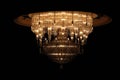 Huge luxurious crystal electric chandelier isolated on a black background