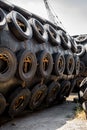 A huge Marine Pneumatic heavy rubber fender surrounded by tires fixed with chains