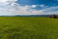 Huge meadow in Javorniky mountains with hills of Beskids mountains on the background Royalty Free Stock Photo