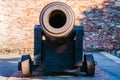 Huge medieval howitzer gun on stone floor as part of outdoor exposition of various artillery weapons on territory of Belgrade