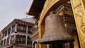 Huge metal clock mounted to a Buddhist temple near famous Boudhanath stupa (Boudha) in Kathmandu, Nepal.