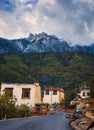 Huge mountain range towering over a traditional village in China